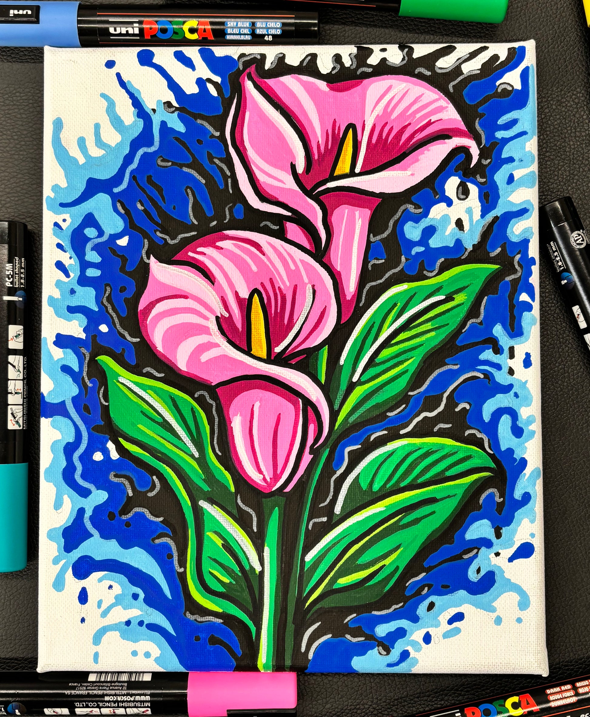 Colorful drawing of pink flowers on a blue background with Uni Posca markers.