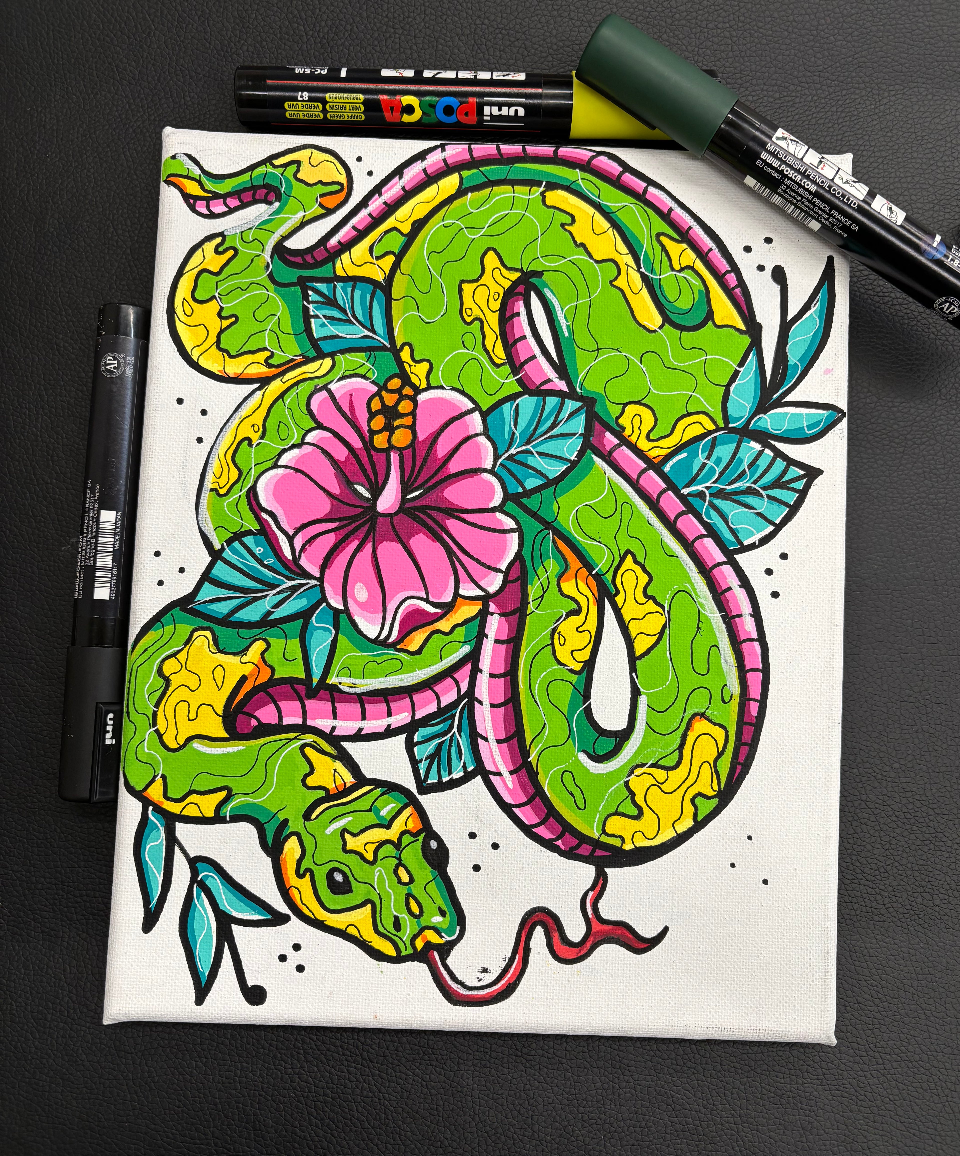 Colorful snake illustration on a white background with markers around. v8x10 acrylic markers on canvas by Hannah Arthur