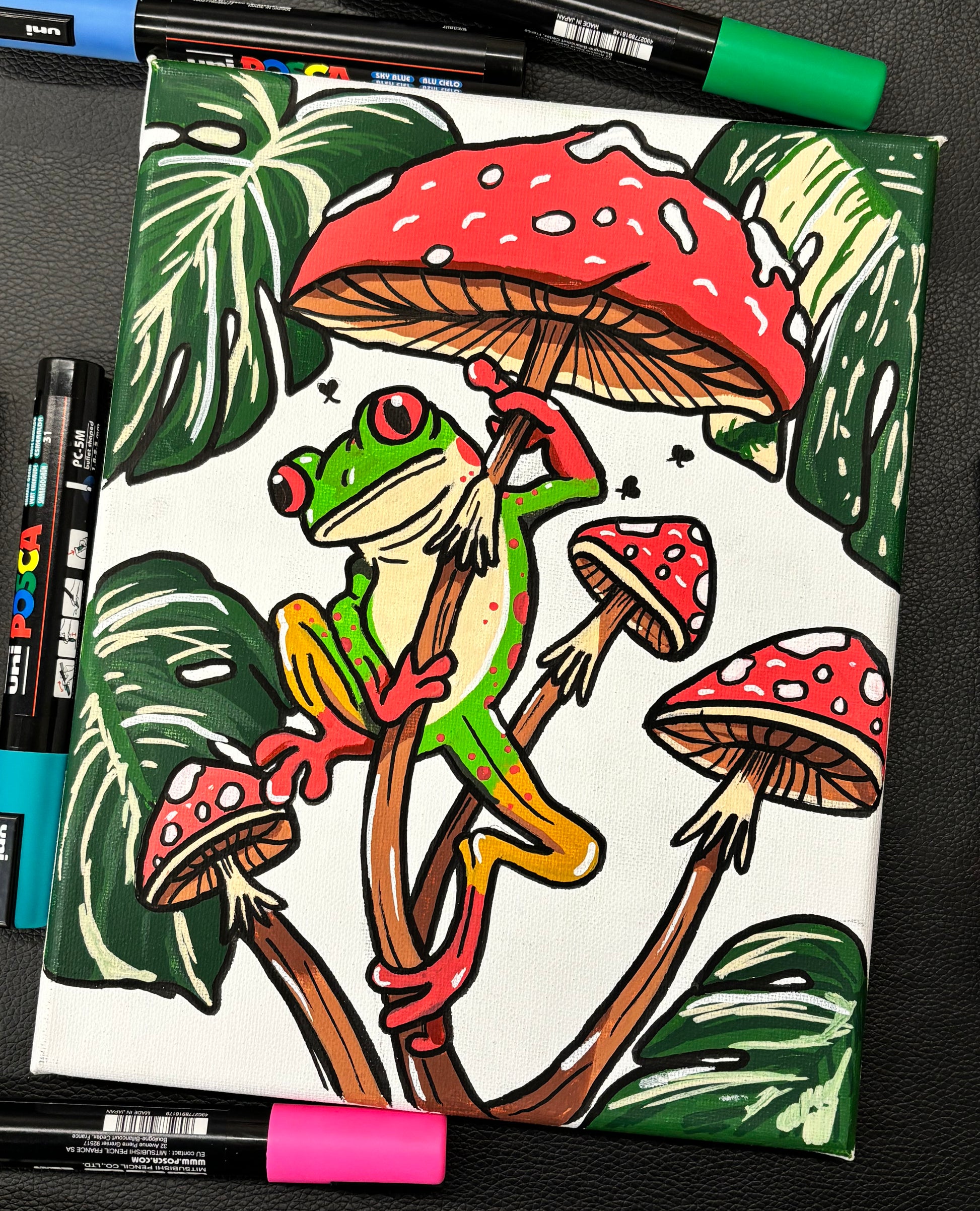 painting of a cute little green tree frog perched on red mushrooms with monstera leaves 